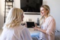 Smiling granddaughter showing her grandmother how to use a tablet Royalty Free Stock Photo