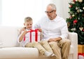 Smiling grandfather and grandson with gift box Royalty Free Stock Photo