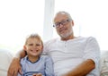 Smiling grandfather and grandson at home