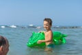 Smiling grandfather and grandson playing and splashing in the sea water. Portrait of happy little kid boy on the beach of ocean. F Royalty Free Stock Photo