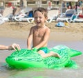 Smiling grandfather and grandson playing and splashing in the sea water. Portrait of happy little kid boy on the beach of ocean. F Royalty Free Stock Photo