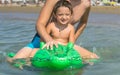 Smiling grandfather and grandson playing and splashing in the sea water. Portrait of happy little kid boy on the beach of ocean. F Royalty Free Stock Photo