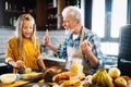 Smiling grandfather helping children to cook in the kitchen Royalty Free Stock Photo