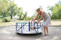 Smiling grandmother with baby granddaughter walking in the park Royalty Free Stock Photo