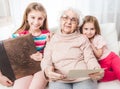 Smiling grandmother with granddaughters looking Royalty Free Stock Photo