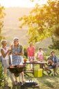 Smiling grandparents drinking wine and enjoying picnic