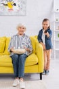 Smiling granny holding bowl with popcorn Royalty Free Stock Photo