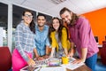 Smiling graphic designers working over photos at desk in office Royalty Free Stock Photo