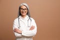 Smiling gray-haired Asian female doctor pediatric, physical, therapist wearing white medical gown Royalty Free Stock Photo