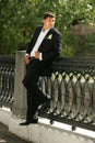 Smiling Groom holding a bouquet