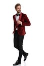 Smiling groom wearing red velvet tuxedo and walking Royalty Free Stock Photo