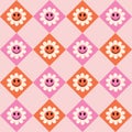 Smiley groovy flowers on pink and orange diamond shapes seamless pattern
