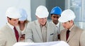 Smiling group of architect examining blueprints Royalty Free Stock Photo