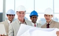 Smiling group of architect examining blueprints Royalty Free Stock Photo