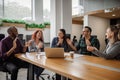 Smiling group of businesspeople clapping together during an office meeting Royalty Free Stock Photo