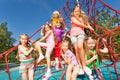 Smiling group of children sit on red ropes Royalty Free Stock Photo