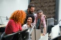 Smiling group of diverse businesspeople going over paperwork together, working in corporate office Royalty Free Stock Photo