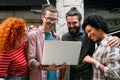 Smiling group of diverse businesspeople going over paperwork together, working in corporate office Royalty Free Stock Photo