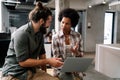 Smiling group of diverse businesspeople going over paperwork together, working in corporate office Royalty Free Stock Photo