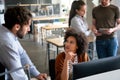 Smiling group of diverse businesspeople going over paperwork together, working in corporate office Royalty Free Stock Photo