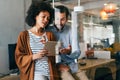 Smiling group of diverse businesspeople going over paperwork together, working in corporate office Royalty Free Stock Photo