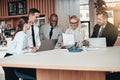 Smiling group of diverse businesspeople working around an office Royalty Free Stock Photo