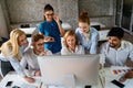 Smiling group of diverse businesspeople working together around a meeting table in an office Royalty Free Stock Photo