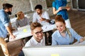 Smiling group of diverse businesspeople working together around a meeting table in an office Royalty Free Stock Photo