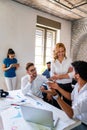 Smiling group of diverse businesspeople working together around a meeting table in an office Royalty Free Stock Photo