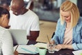 Smiling group of diverse colleagues working around an office tab Royalty Free Stock Photo