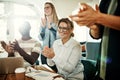 Smiling group of diverse office colleagues clapping during a meeting Royalty Free Stock Photo