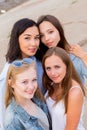 Smiling group of female students in summer clothes posing together outdoor and looking at camera Royalty Free Stock Photo