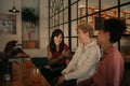 Smiling group of girlfriends talking over drinks in a bar Royalty Free Stock Photo