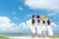 Smiling group woman wearing fashion white dress summer walking on the sandy ocean beach, beautiful blue sky background. Royalty Free Stock Photo