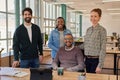 Smiling group of young businesspeople working together in an office Royalty Free Stock Photo