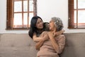 smiling grownup daughter hugging older mother. two generations concept, beautiful young woman embracing mature woman Royalty Free Stock Photo