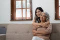 smiling grownup daughter hugging older mother. two generations concept, beautiful young woman embracing mature woman Royalty Free Stock Photo