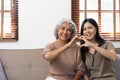 smiling grownup daughter hugging older mother. two generations concept, beautiful young woman embracing mature woman Royalty Free Stock Photo