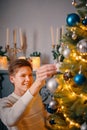 Smiling guy decorating Christmas tree. Royalty Free Stock Photo