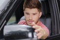 smiling guy fixing rear view mirror car Royalty Free Stock Photo