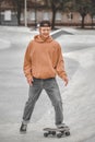 Smiling guy looking at skateboard in skatepark Royalty Free Stock Photo