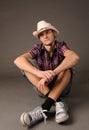 Smiling guy in sneakers and hat Royalty Free Stock Photo