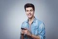 Smiling guy texting with smartphone