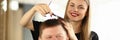 Smiling Hairdresser Combing Hair of Male Client Royalty Free Stock Photo