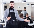 Hairdresser demonstrating his workplace