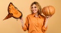 Smiling Halloween Witch with Pumpkin. Happy girl with magic witches hat. Trick or treat. Halloween time. Royalty Free Stock Photo