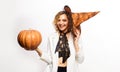 Smiling Halloween woman in witch hat with Jack-o-lantern pumpkin. Beautiful young girl in magic hat with pumpkin Royalty Free Stock Photo