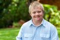 Smiling handicapped boy outdoors.