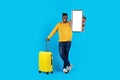 Smiling Handsome Black Man With Suitcase And Blank Smartphone In Hand Royalty Free Stock Photo