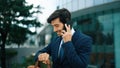 Smiling handsome business man looking at time while calling manager. Exultant. Royalty Free Stock Photo